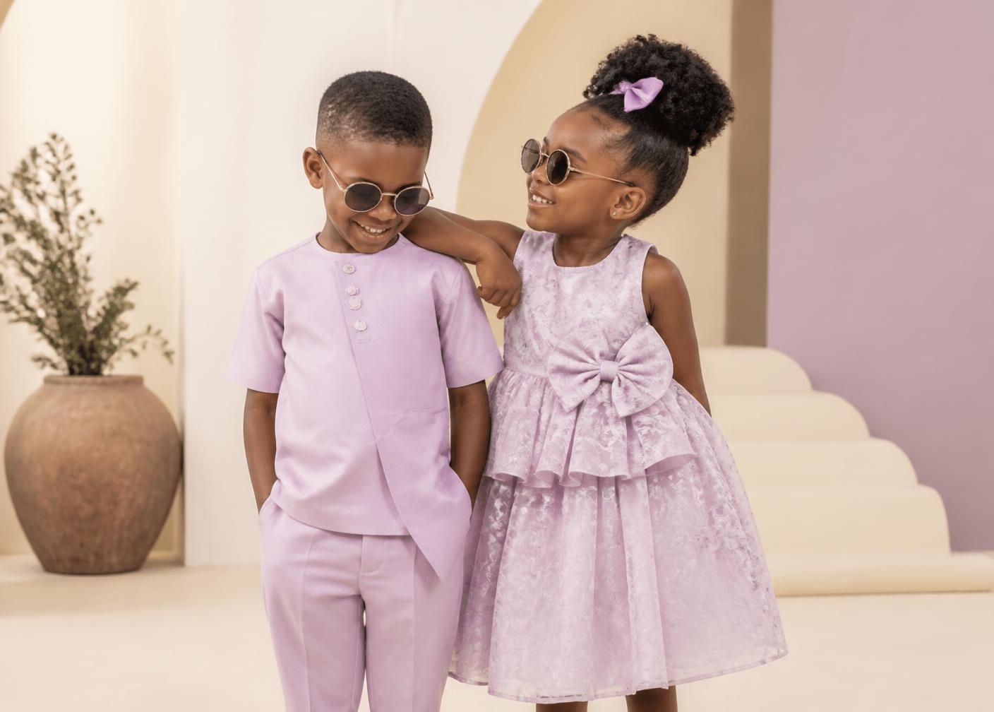 Two children wearing elegant coordinated lilac outfits